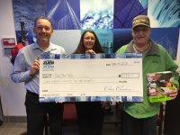 Zurn associates deliver a check to a representative of the Marine Toys for Tots organization (Zurn associates left to right): Ed Stettler and Tammi Keyes 