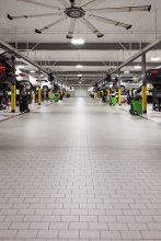 The service area and showroom host dozens of cars, each weighing thousands of pounds.